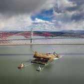 Aerial image of the Iron Lady barge with its cargo of a topside drilling platform for decommissioning being towed by Forth Ports tugs at the Forth Bridges into The Port of Rosyth on Sunday , April 11. Credit: Airbourne Lens