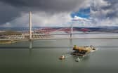 Aerial image of the Iron Lady barge with its cargo of a topside drilling platform for decommissioning being towed by Forth Ports tugs at the Forth Bridges into The Port of Rosyth on Sunday , April 11. Credit: Airbourne Lens