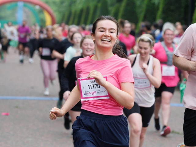 This runner ploughs on to the finishing line of the race in Glasgow on Sunday. PIC: Steve Welsh.
