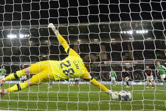 Hearts goalkeeper Zander Clark plunges to his right to save Martin Boyle's penalty in the win over Hibs.