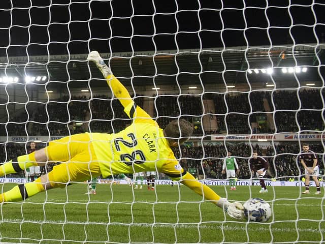 Hearts goalkeeper Zander Clark plunges to his right to save Martin Boyle's penalty in the win over Hibs.
