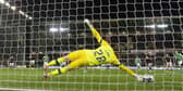 Hearts goalkeeper Zander Clark plunges to his right to save Martin Boyle's penalty in the win over Hibs.