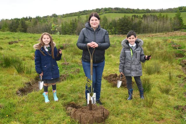 Councillor Susan Aitken, chair of Glasgow City Region cabinet and leader of Glasgow City Council, gets digging with local children as plans are unveiled to plant 18 million trees - ten for every adult and child in the area - as part of the new Clyde Climate Forest initiative