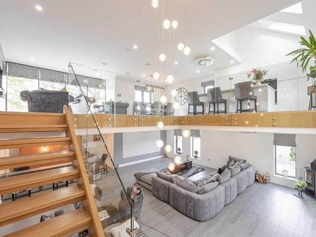 Lit with windows spanning the height of both floors and stunning hanging light fittings, the open tread oak stair links the two social areas.