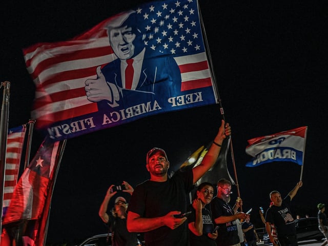 Suppoerters of former US President Donald Trump stand outside his residence residence in Mar-A-Lago, Florida on August 8, 2022.