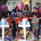 Mourners visit memorials for victims of Tuesday's mass shooting at a Texas elementary school.