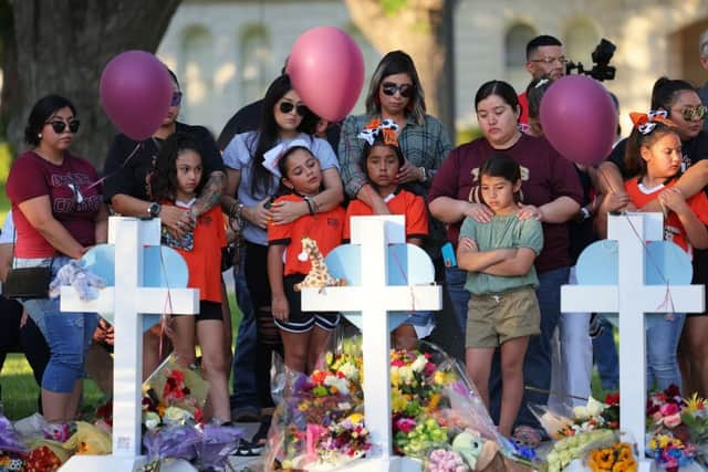Mourners visit memorials for victims of Tuesday's mass shooting at a Texas elementary school.