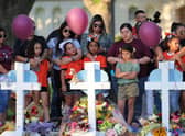 Mourners visit memorials for victims of Tuesday's mass shooting at a Texas elementary school.