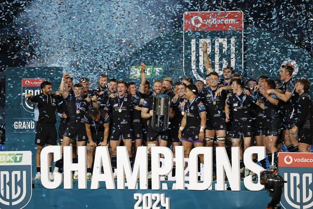 Glasgow Warriors players celebrate with the trophy after winning the United Rugby Championship at Loftus Versfeld stadium in Pretoria last season. (Photo by PHILL MAGAKOE/AFP via Getty Images)