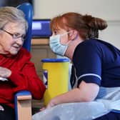 Resident Annie Innes, 90, talks with a healthcare worker after receiving the Pfizer/BioNTech COVID-19 vaccine at the Abercorn House Care Home in Hamilton.