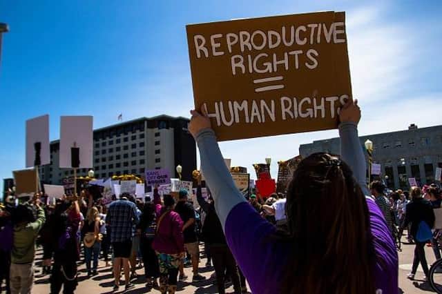 RENO, NEVADA, UNITED STATES - 2022/05/07: A protester holds a placard up that says "Reproductive rights = Human rights". Protestors gathered to voice their anger at the leaked Supreme Court documents. (Photo by Ty O'Neil/SOPA Images/LightRocket via Getty Images)