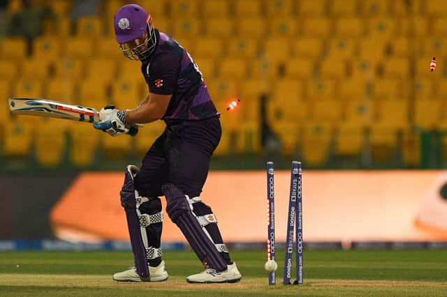 Scotland's George Munsey is bowled out by Namibia's Ruben Trumpelmann. (Photo by INDRANIL MUKHERJEE/AFP via Getty Images)