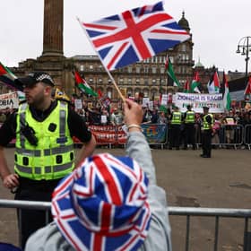 Supporters of a Pro-UK Rally endorsed by Tommy Robinson gather in George Square as activists from Stand Up to Racism Scotland also held a demonstration (Photo by Jeff J Mitchell/Getty Images)