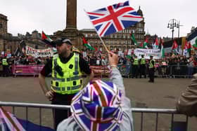Supporters of a Pro-UK Rally endorsed by Tommy Robinson gather in George Square as activists from Stand Up to Racism Scotland also held a demonstration (Photo by Jeff J Mitchell/Getty Images)