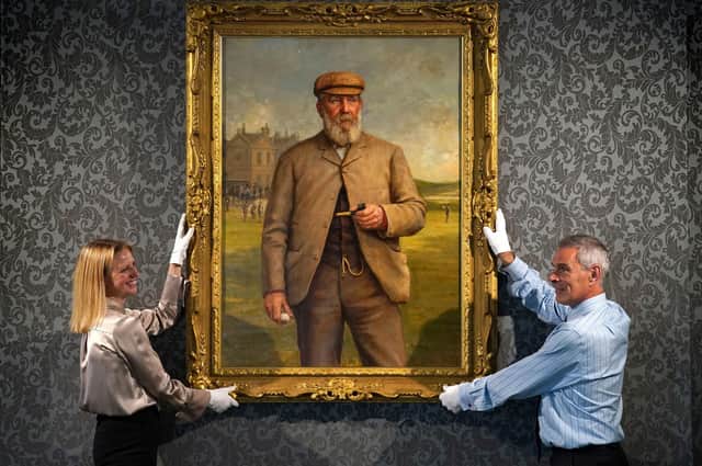 May Matthews and Charles Graham-Campbell from Bonhams with a 'Portrait of Tom Morris Senior' by Henry Brooks