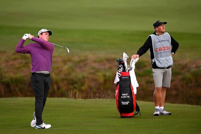 Bob Macintyre and caddie Mike Thomson watch his second shot on the tenth hole during the second round of the Cazoo Open de France at Le Golf National. Picture: Ross Kinnaird/Getty Images.