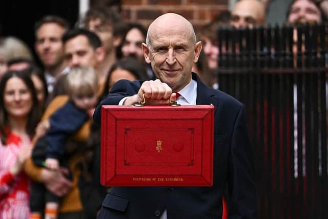 Chancellor of the Exchequer John Healey holds up the traditional red ministerial box outside No 11 Downing Street before delivering his Budget yesterday (Picture: Dylan Martinez - WPA Pool/Getty Images)