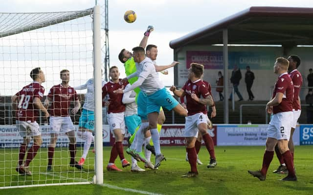 Arbroath's Derek Gaston attempts to punch clear under pressure from Inverness' Shane Sutherland.