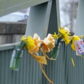 Flowers, and ribbons on a bridge over the River Wyre in St Michael's on Wyre, Lancashire, where police recovered a body on Sunday, which was found by members of the public close to where Nicola Bulley disappeared on January 27. Ms Bulley, 45, was last seen walking her dog nearby, on a footpath along the River Wyre, after dropping her daughters, aged six and nine, at school. Picture date: Monday February 20, 2023.