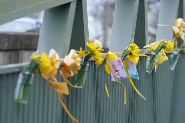 Flowers, and ribbons on a bridge over the River Wyre in St Michael's on Wyre, Lancashire, where police recovered a body on Sunday, which was found by members of the public close to where Nicola Bulley disappeared on January 27. Ms Bulley, 45, was last seen walking her dog nearby, on a footpath along the River Wyre, after dropping her daughters, aged six and nine, at school. Picture date: Monday February 20, 2023.