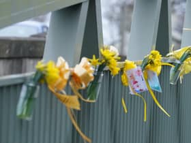 Flowers, and ribbons on a bridge over the River Wyre in St Michael's on Wyre, Lancashire, where police recovered a body on Sunday, which was found by members of the public close to where Nicola Bulley disappeared on January 27. Ms Bulley, 45, was last seen walking her dog nearby, on a footpath along the River Wyre, after dropping her daughters, aged six and nine, at school. Picture date: Monday February 20, 2023.