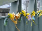 Flowers, and ribbons on a bridge over the River Wyre in St Michael's on Wyre, Lancashire, where police recovered a body on Sunday, which was found by members of the public close to where Nicola Bulley disappeared on January 27. Ms Bulley, 45, was last seen walking her dog nearby, on a footpath along the River Wyre, after dropping her daughters, aged six and nine, at school. Picture date: Monday February 20, 2023.