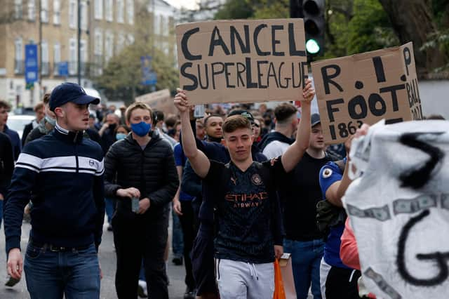 Football supporters demonstrated against the proposed European Super League outside of Stamford Bridge.