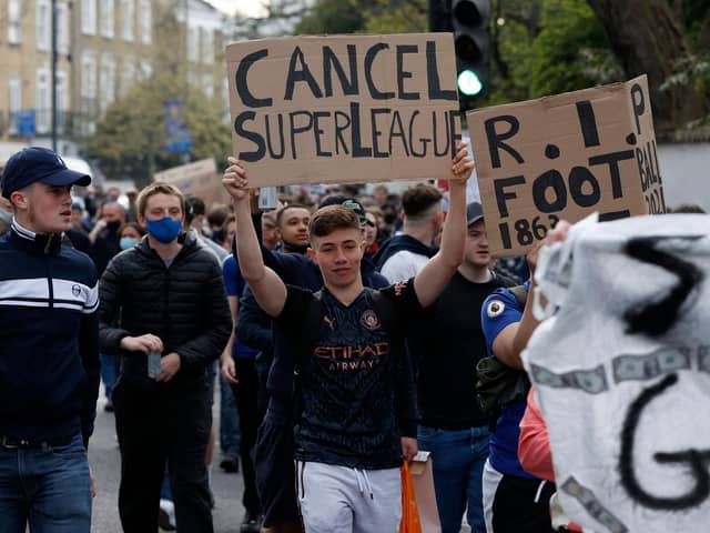 Football supporters demonstrated against the proposed European Super League outside of Stamford Bridge.