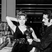 Spanish fashion designer Paco Rabanne tries a creation with cutleries on French actress Corinne Marchand during the Home economics (or domestic science) exhibition at the shopping mall of Saint-Laurent-du-Var.