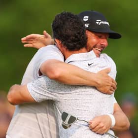 Michael Block and playing partner Rory McIlroy share a huge hug on the 18th green during the final round of the PGA Championship at Oak Hill Country Club in Rochester, New York. Picture: Andrew Redington/Getty Images.