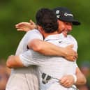 Michael Block and playing partner Rory McIlroy share a huge hug on the 18th green during the final round of the PGA Championship at Oak Hill Country Club in Rochester, New York. Picture: Andrew Redington/Getty Images.