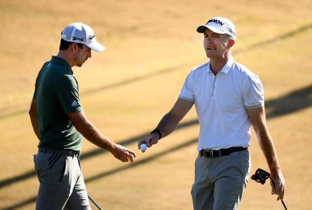 Martin Laird, right, reacts after saving a par as Nick Taylor of Canada looks on during the first round of The American Express tournament on the Jack Nicklaus Tournament Course at PGA West in La Quinta, California. Picture: Harry How/Getty Images.