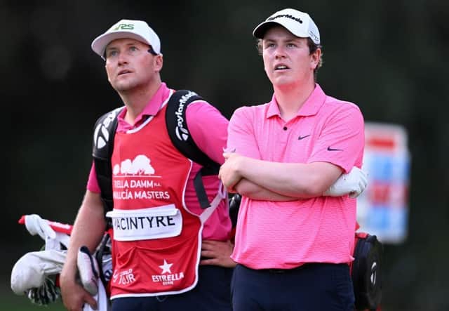 Bob MacIntyre and his caddie Mike Thomson watch a shot from one of the players in their group during the first round of the Estrella Damm N.A. Andalucía Masters at Real Club Valderrama in Cadiz. Picture: Ross Kinnaird/Getty Images.