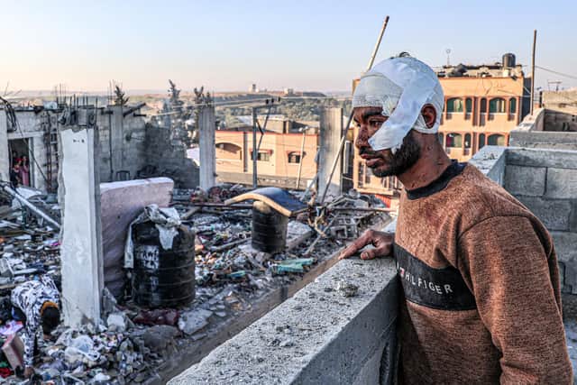 An injured man looks out on a scene of devastation following Israeli missile strikes on Rafah in the southern Gaza Strip earlier this month (Picture: Said Khatib/AFP via Getty Images)