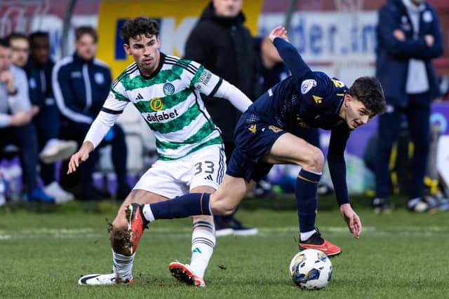 Dundee left-back Owen Beck tangles with Celtic's Matt O'Riley during the Boxing Day clash at Dens Park. (Photo by Ross Parker / SNS Group)