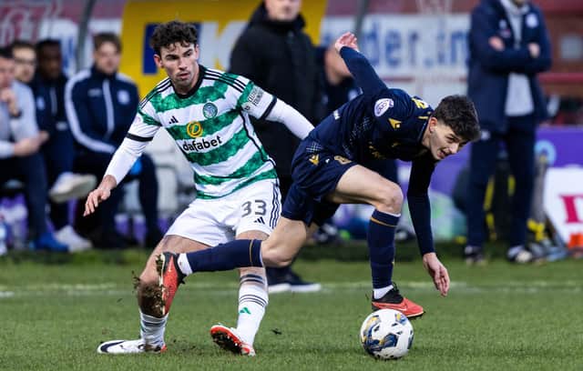 Dundee left-back Owen Beck tangles with Celtic's Matt O'Riley during the Boxing Day clash at Dens Park. (Photo by Ross Parker / SNS Group)
