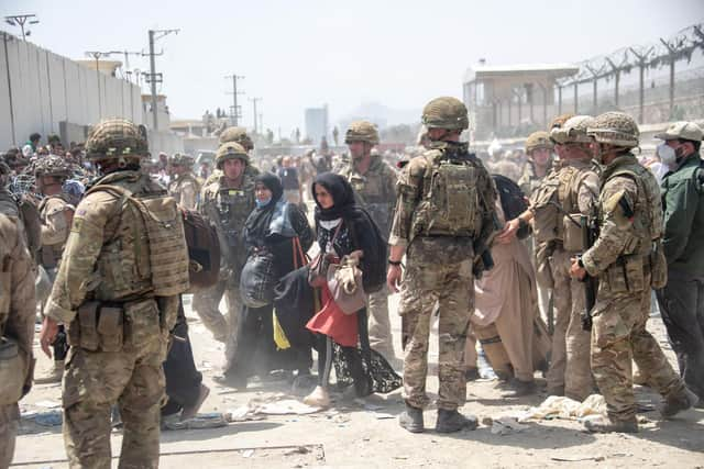 Members of the British and US military engaged in the evacuation of people out of Kabul, Afghanistan.