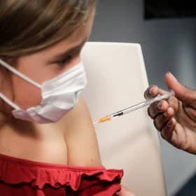 (FILES) This file photo taken on December 17, 2021 shows a child receiving a dose of the Pfizer/BioNTech vaccine against Covid-19, in Paris. - The vaccination of children aged 5 to 11 is officially open, French Health Minister Olivier Veran announced on December 22, 2021, although he said the booster dose had not been extended to teenagers "for the moment". (Photo by GEOFFROY VAN DER HASSELT / AFP) (Photo by GEOFFROY VAN DER HASSELT/AFP via Getty Images)