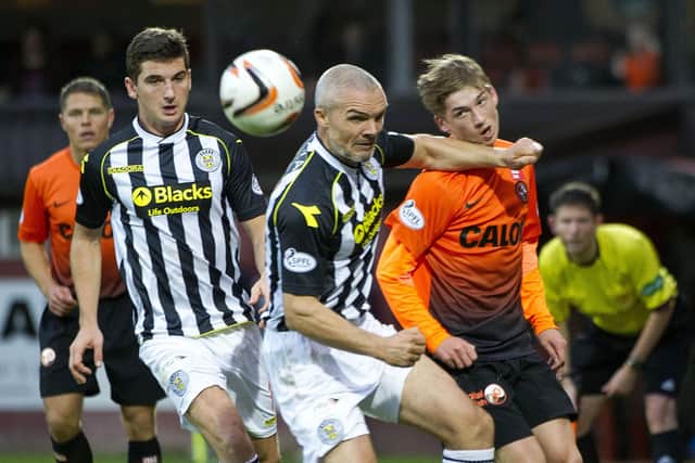 Jim Goodwin uses his strength to hold off Dundee United's Ryan Gauld during a match between them and St Mirren in 2013.