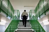 A prison guard walks through a cell area. Picture: Dan Kitwood/Getty Images