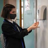 A pupil at a school in Scotland using a hand sanitiser station as schools reopened after lockdown picture: JPI Media