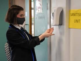 A pupil at a school in Scotland using a hand sanitiser station as schools reopened after lockdown picture: JPI Media