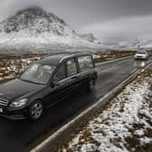 The funeral cortege of Dr Hamish MacInnesmakes its way past Buachaille Etive Mor in Glencoe