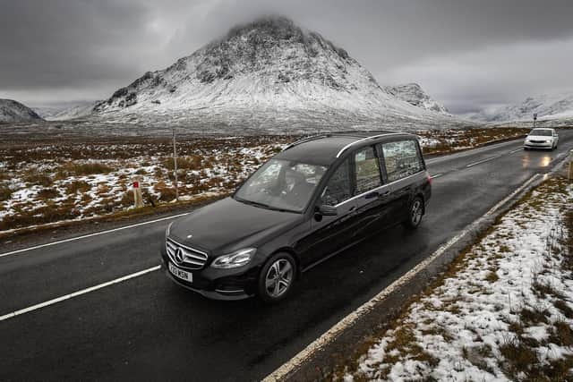 The funeral cortege of Dr Hamish MacInnesmakes its way past Buachaille Etive Mor in Glencoe