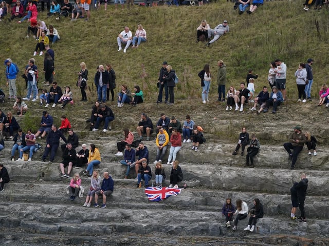 People wait to view the hearse carrying the coffin when it passes through the Queensferry Crossing (Pic: PA/Owen Humphreys)