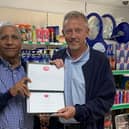 Postmaster Iqbal Mohammed receiving Post Office 30 Years' Long Service Award from Area Manager Brian McNaughton