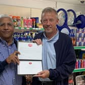 Postmaster Iqbal Mohammed receiving Post Office 30 Years' Long Service Award from Area Manager Brian McNaughton