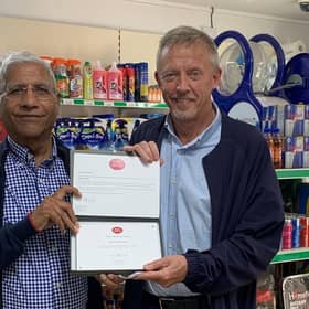 Postmaster Iqbal Mohammed receiving Post Office 30 Years' Long Service Award from Area Manager Brian McNaughton