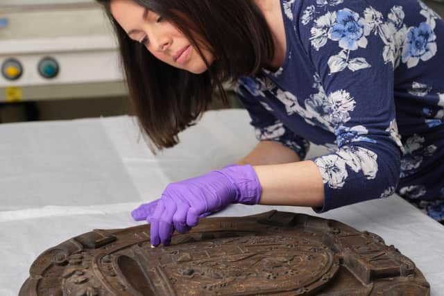 Conservator Gemma Frew works on the armorial panel from Mary de Guise's former residence at Blythe's Court off Castlehill. PIC: NMS.