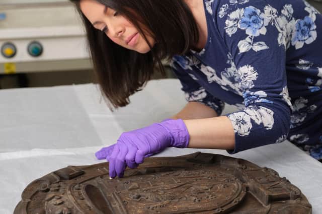 Conservator Gemma Frew works on the armorial panel from  Mary de Guise's former residence at Blythe's Court off Castlehill. PIC: NMS.